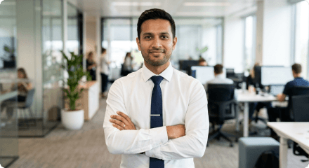 A man standing with his arms crossed in an office